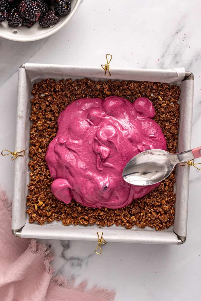 Spreading blackberry layer evenly over crust