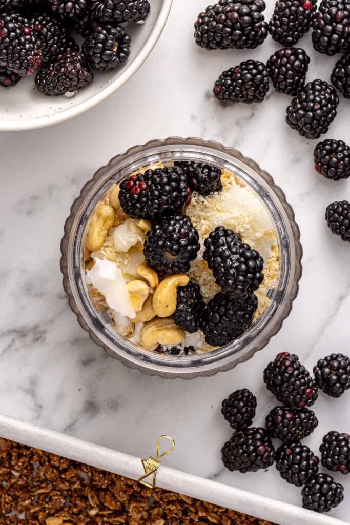 Blender filled with blackberry mixture for healthy dessert bars