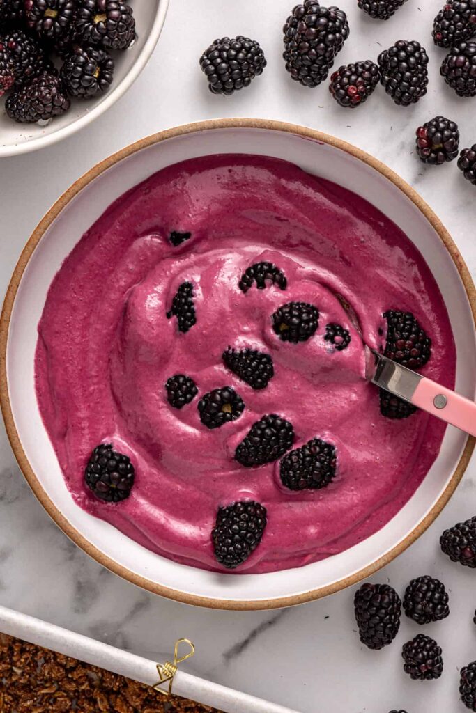 Folding fresh blackberries into creamy filling for cobbler bars