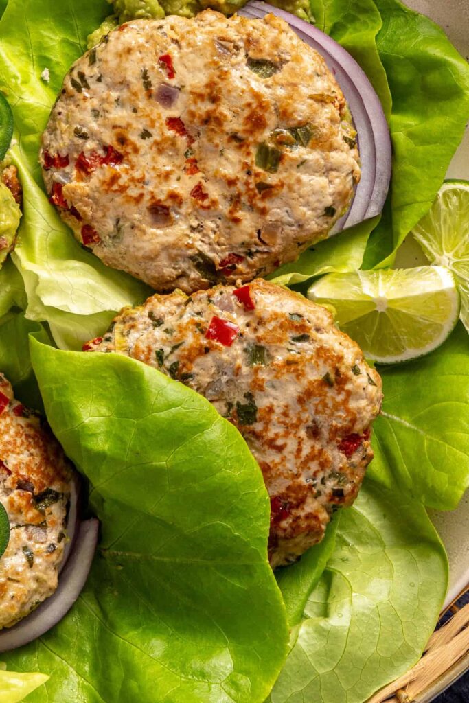 Jalapeño burgers plated with fresh toppings and sides