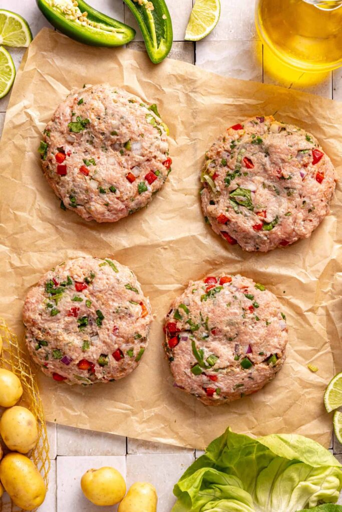 Uncooked jalapeño burgers formed into patties