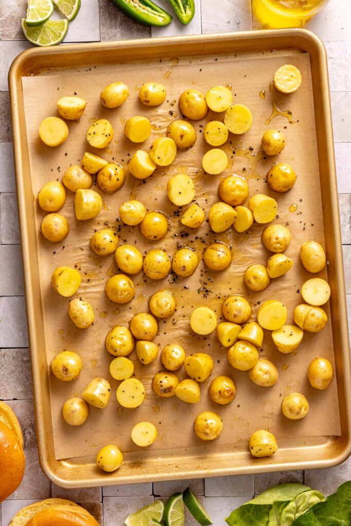 Sliced baby potatoes seasoned for roasting