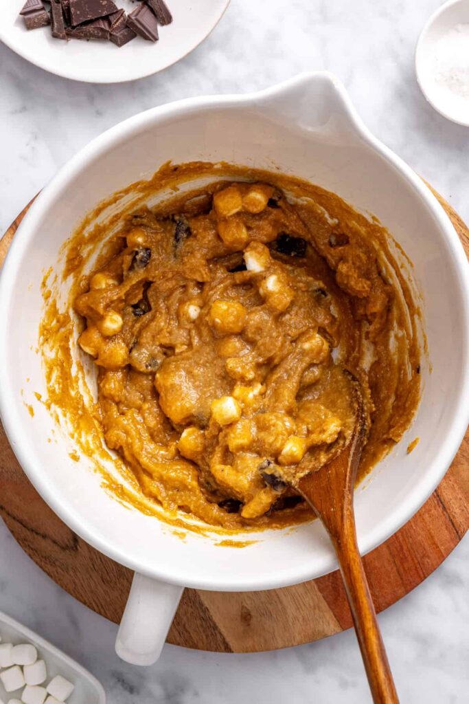 Stirring graham crackers into homemade s'mores cookie skillet dough