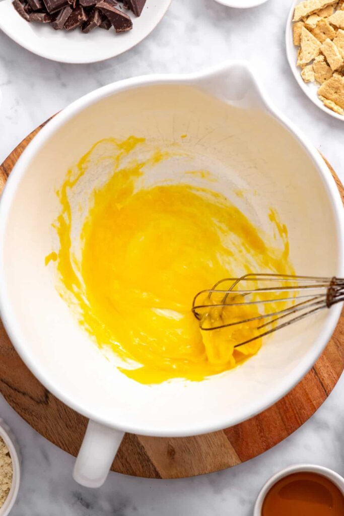 whisking eggs for a gluten-free, dairy-free s'mores cookie skillet