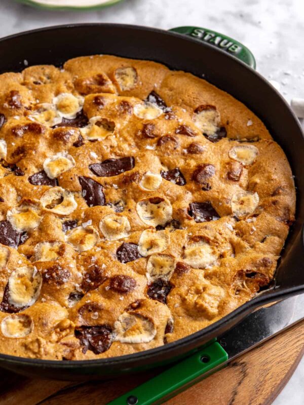 Gluten-free s'mores cookie skillet baked in a cast-iron skillet with melted marshmallows, chocolate and graham cracker pieces