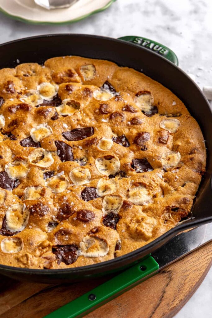 Gluten-free s'mores cookie skillet baked in a cast-iron skillet with melted marshmallows, chocolate and graham cracker pieces
