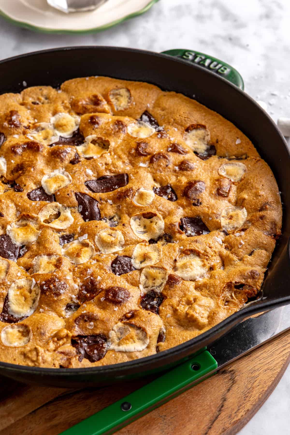 Gluten-free s'mores cookie skillet baked in a cast-iron skillet with melted marshmallows, chocolate and graham cracker pieces