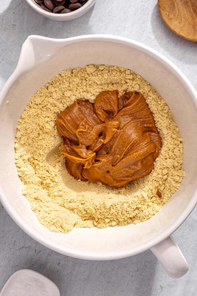 Combining wet and dry ingredients to form protein bar dough
