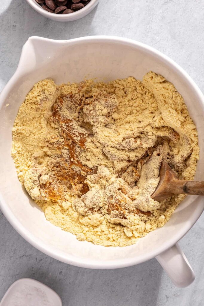 Stirring peanut butter mixture into dry ingredients for protein bars