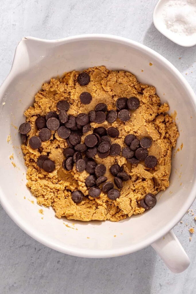 Folding chocolate chips into peanut butter protein bar mixture