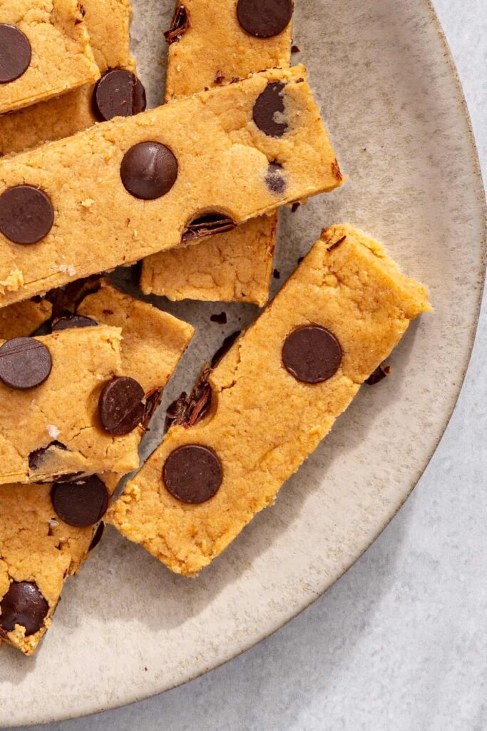 Peanut butter protein bars on plate, overhead partial frame