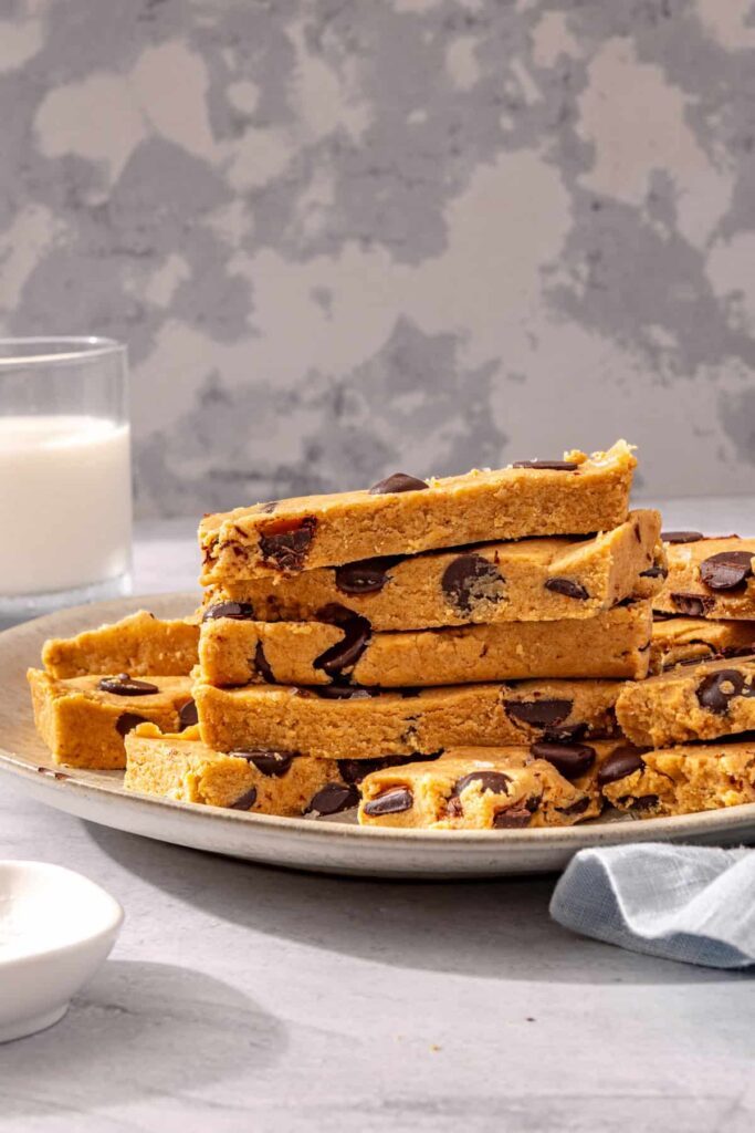 Snack setup with peanut butter protein bars, milk, and a napkin