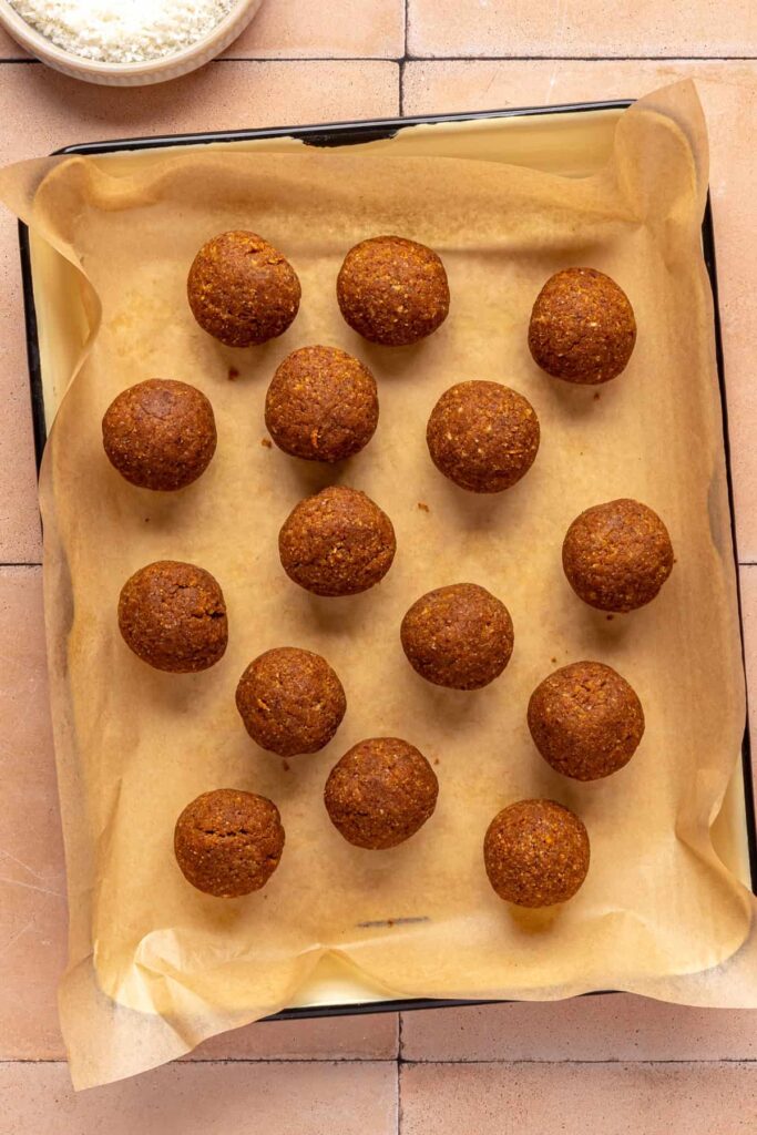 bite-sized pumpkin protein balls before rolling in shredded coconut topping