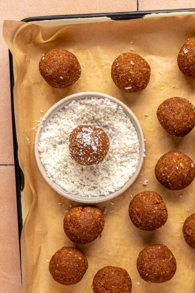 Rolling pumpkin protein ball mixture into bite-sized balls before chilling