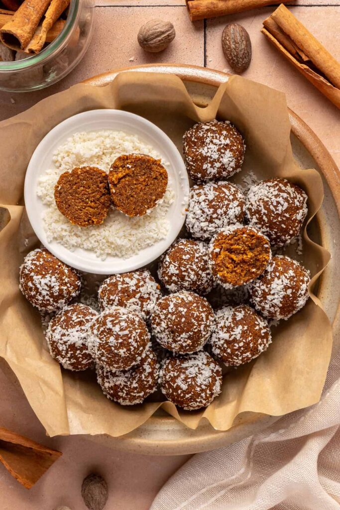 Healthy pumpkin protein balls in a bowl topped with shredded coconut