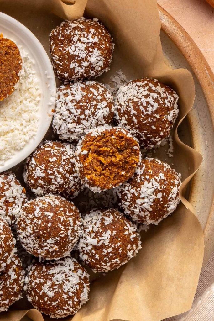 Pumpkin protein balls rolled in shredded coconut for a healthy fall snack