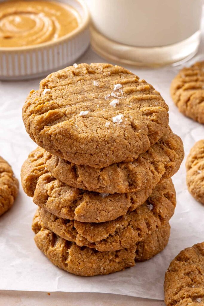 Stack of gluten-free peanut butter cookies served with a glass of milk