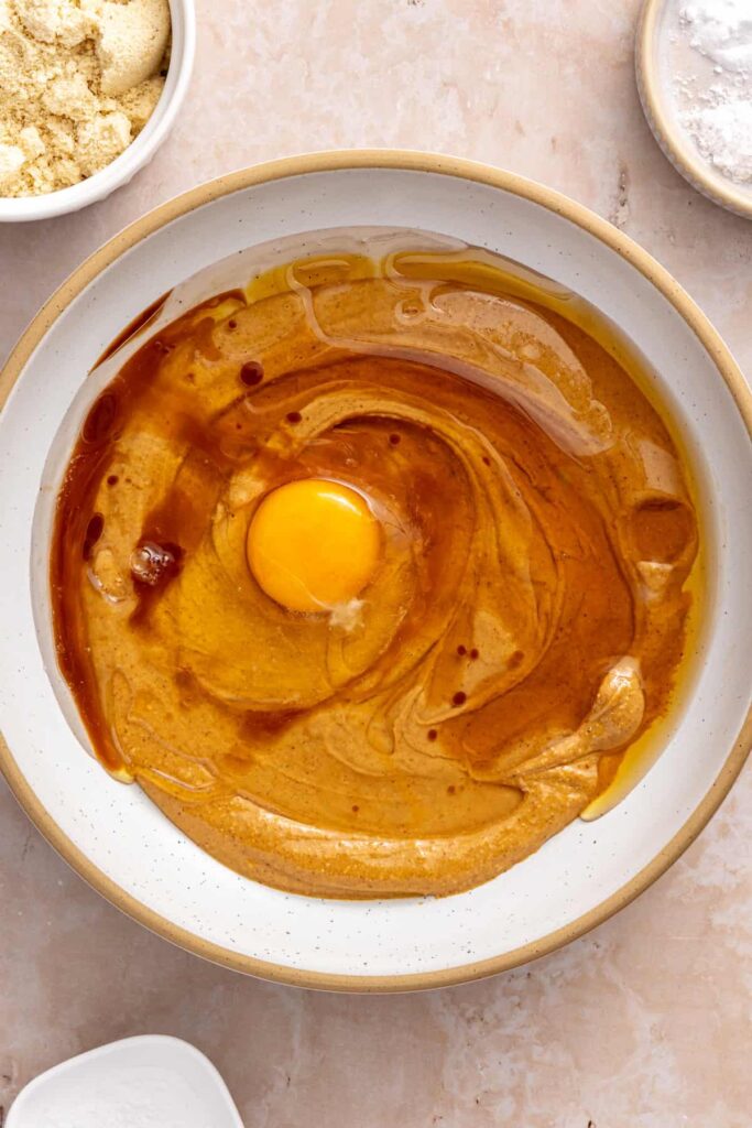 Wet ingredients mixed in a bowl for homemade gluten-free peanut butter cookies