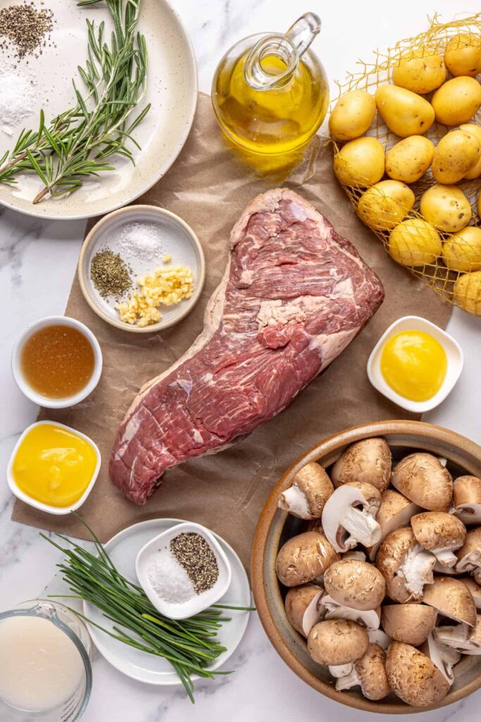 Prepped ingredients for making tri-tip steak with creamy mashed potatoes and sautéed garlic mushrooms, ready to cook
