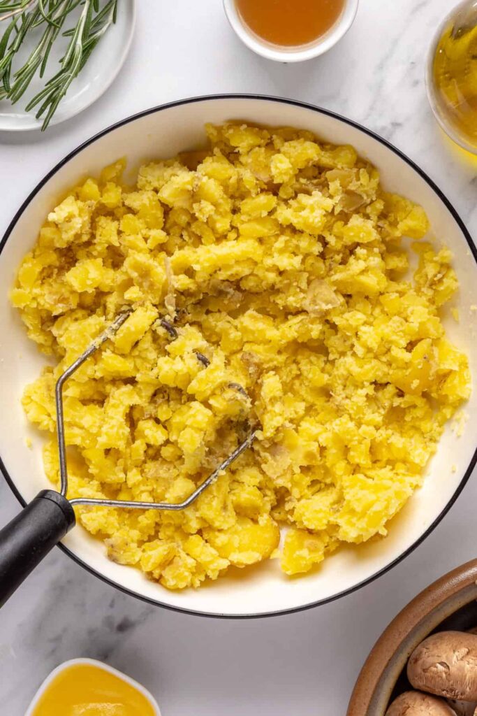 Fluffy mashed mini potatoes with ghee and almond milk, topped with fresh chives and olive oil drizzle