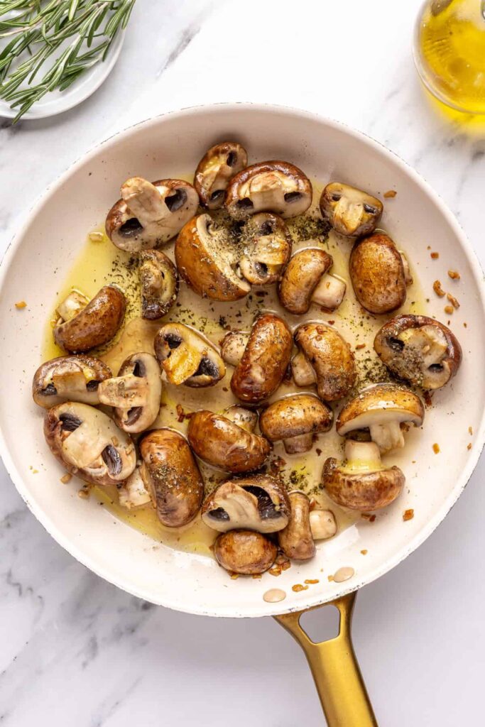 Garlicky mushrooms cooking in ghee and olive oil