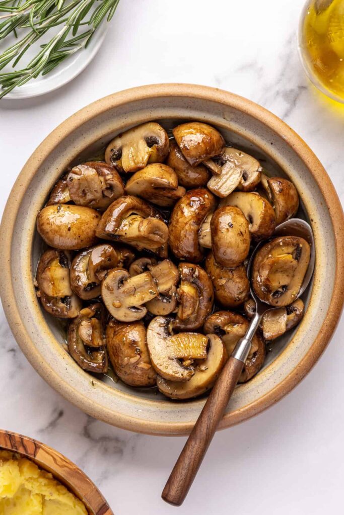 Garlicky mushrooms cooked in ghee and olive oil, garnished with chopped chives, served warm