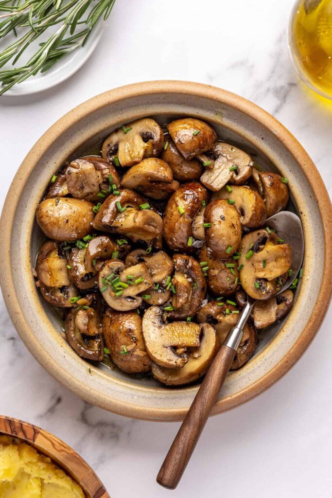 Sautéed cremini mushrooms with garlic and Italian seasoning, finished with fresh chives and flaky sea salt