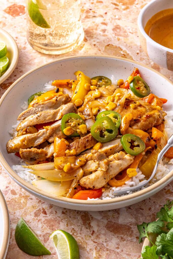 Side view of southwest chicken skillet bowl with rice and sauce