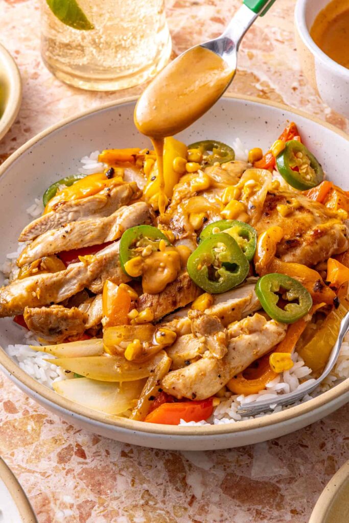 Spicy southwest chicken skillet served over rice with chipotle ranch drizzle