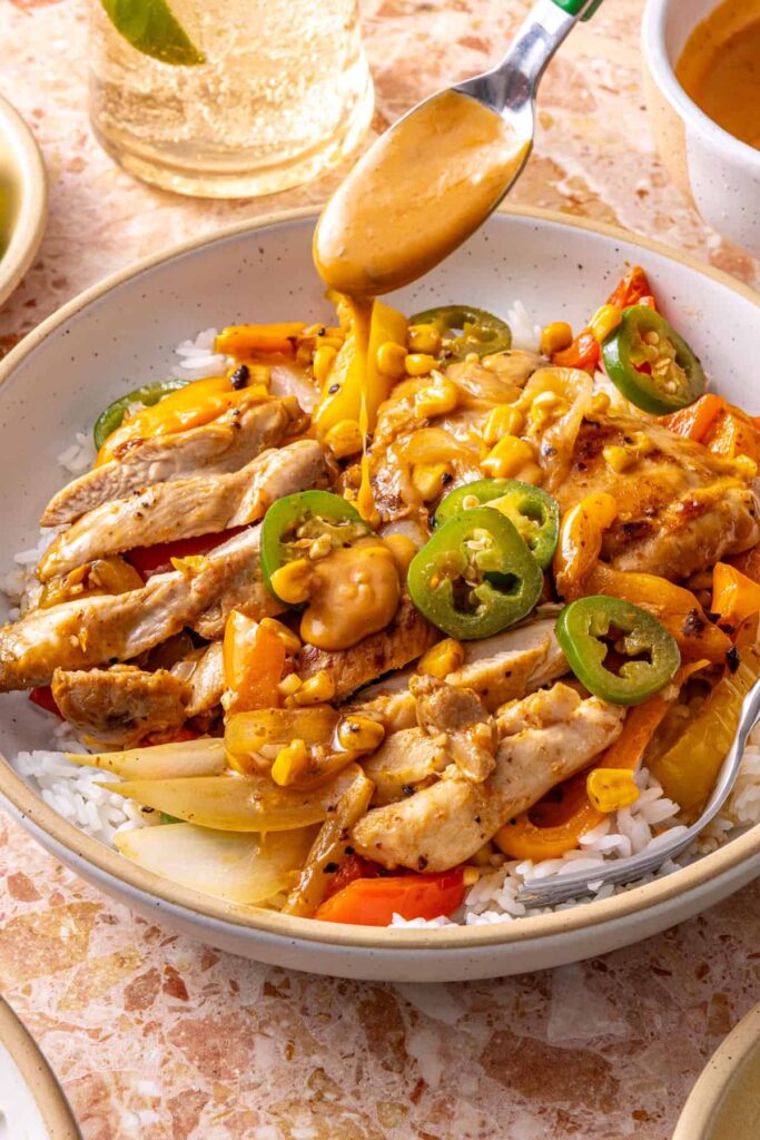 Healthy southwest chicken skillet served for dinner with extra drizzle of dressing