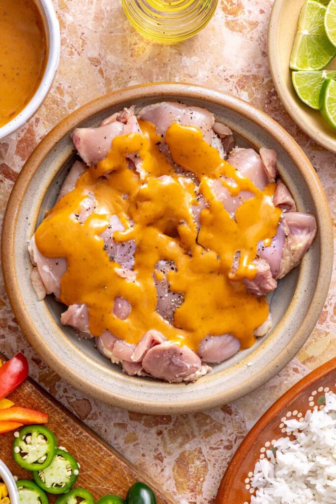 Marinating chicken for southwest chicken skillet with spices and dressing