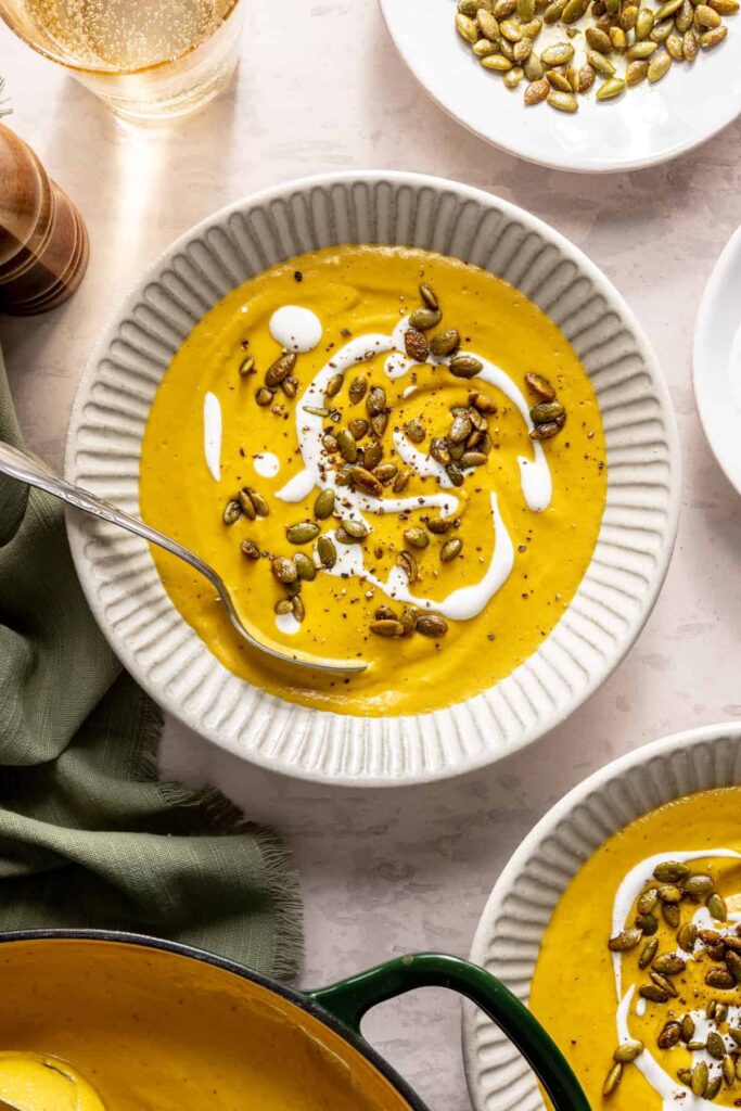 Kabocha cashew curry soup served with pumpkin seed topping – gluten-free, dairy-free recipe