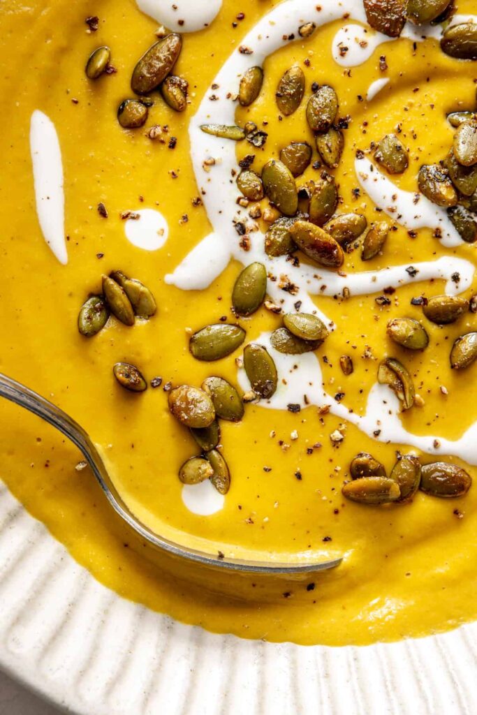 Kabocha cashew curry soup served with pumpkin seed topping – gluten-free, dairy-free recipe