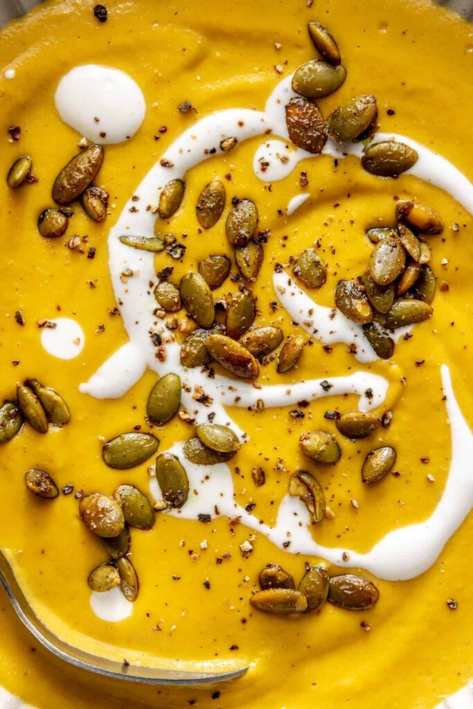 Kabocha cashew curry soup served with pumpkin seed topping – gluten-free, dairy-free recipe