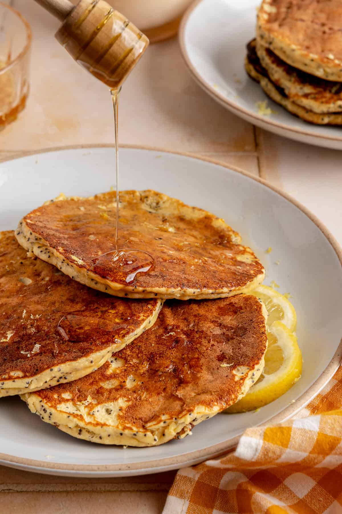 Healthy, gluten-free and dairy-free lemon poppyseed protein pancakes stacked on a plate