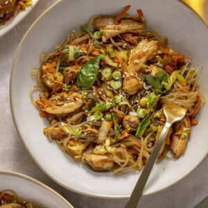 Gluten-free honey garlic chicken stir fry with sweet potato glass noodles served in a bowl.