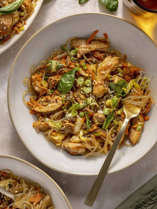Gluten-free honey garlic chicken stir fry with sweet potato glass noodles served in a bowl.