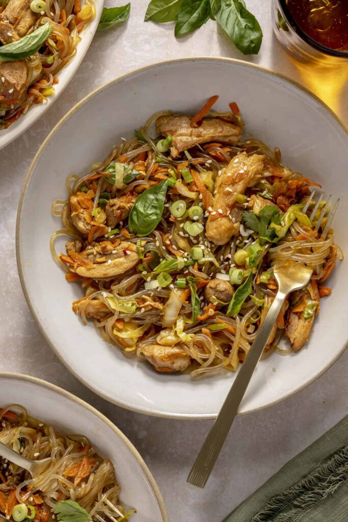 Gluten-free honey garlic chicken stir fry with sweet potato glass noodles served in a bowl.