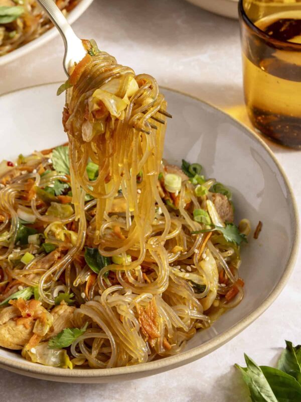 Gluten-free honey garlic chicken stir fry with sweet potato glass noodles served in a bowl.