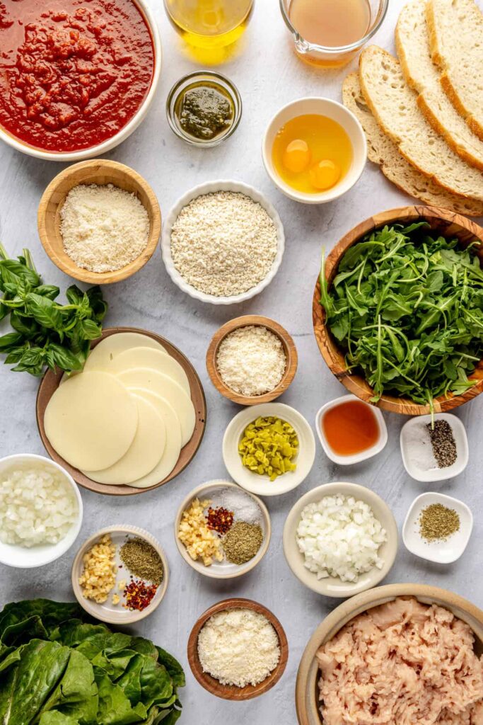 Ingredients for chicken pesto parmesan meatballs: ground chicken, pesto, parmesan, breadcrumbs