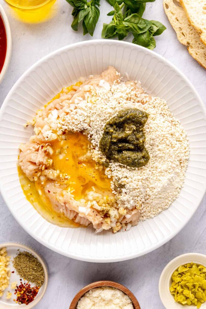 Ingredients for chicken pesto parmesan meatballs: ground chicken, pesto, parmesan, breadcrumbs