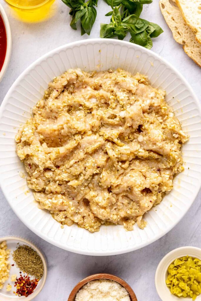 Ingredients for chicken pesto parmesan meatballs: ground chicken, pesto, parmesan, breadcrumbs