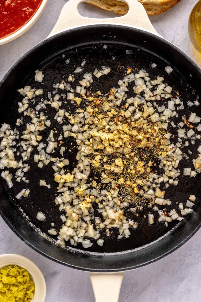 making the marinara sauce for chicken pesto parmesan meatballs