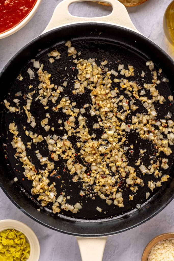 making the marinara sauce for chicken pesto parmesan meatballs