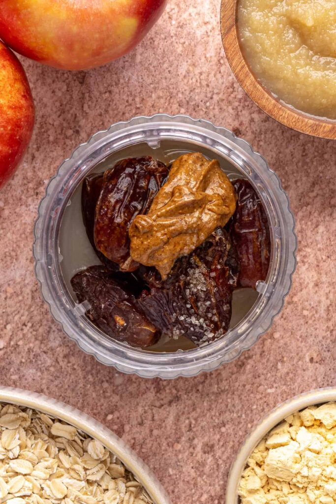 overhead view of ingredients for smooth date caramel in a blender for baked apple oatmeal