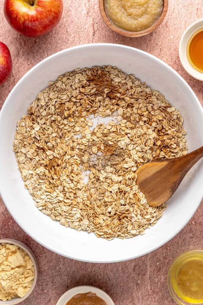 mixing dry ingredients for baked apple oatmeal in a mixing bowl
