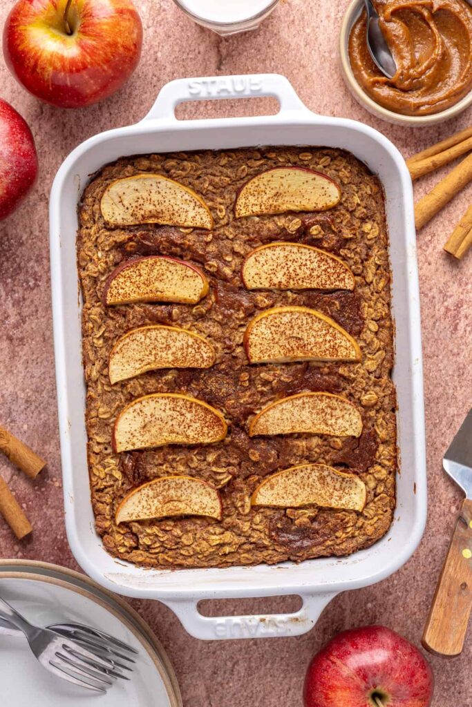 Overhead view of freshly baked apple oatmeal with caramel and sliced apples, ready to serve