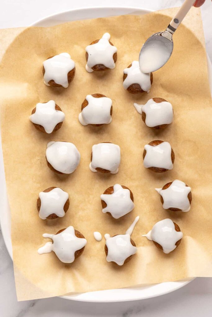 drizzling coconut butter drizzle on gingerbread protein balls