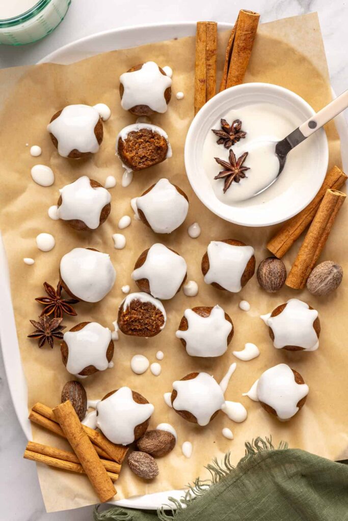 Chewy gingerbread protein balls with coconut butter drizzle and cinnamon, perfect for holiday snacks or meal prep