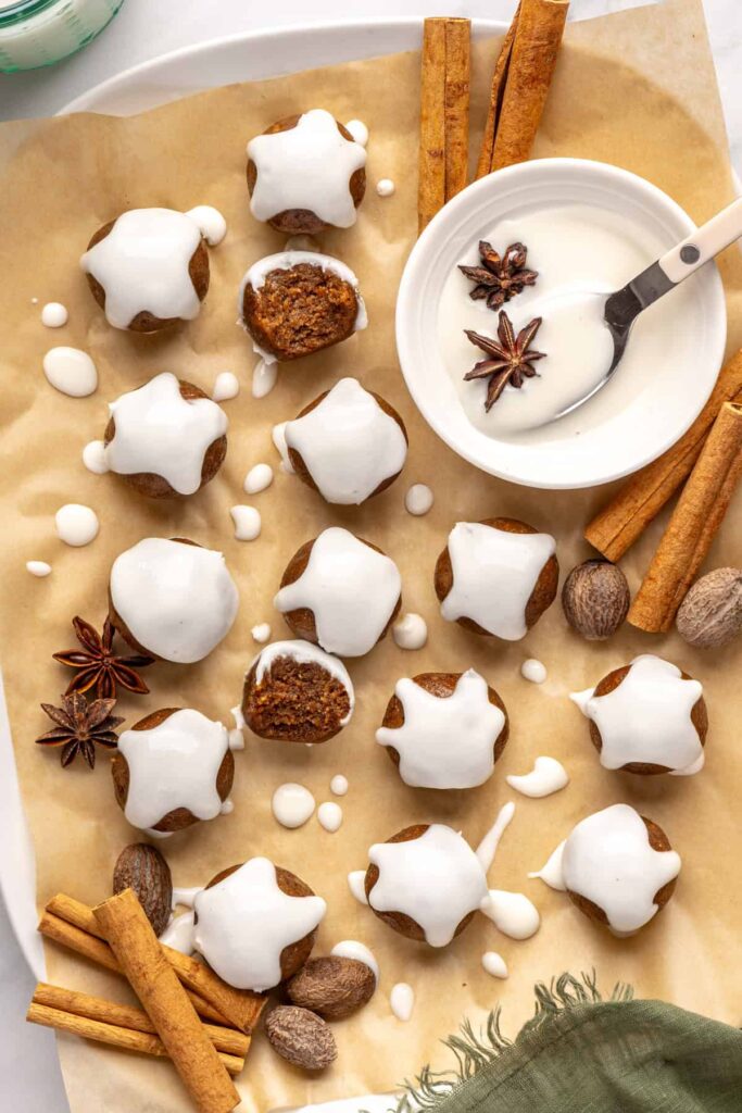 Chewy gingerbread protein balls with coconut butter drizzle and cinnamon, perfect for holiday snacks or meal prep